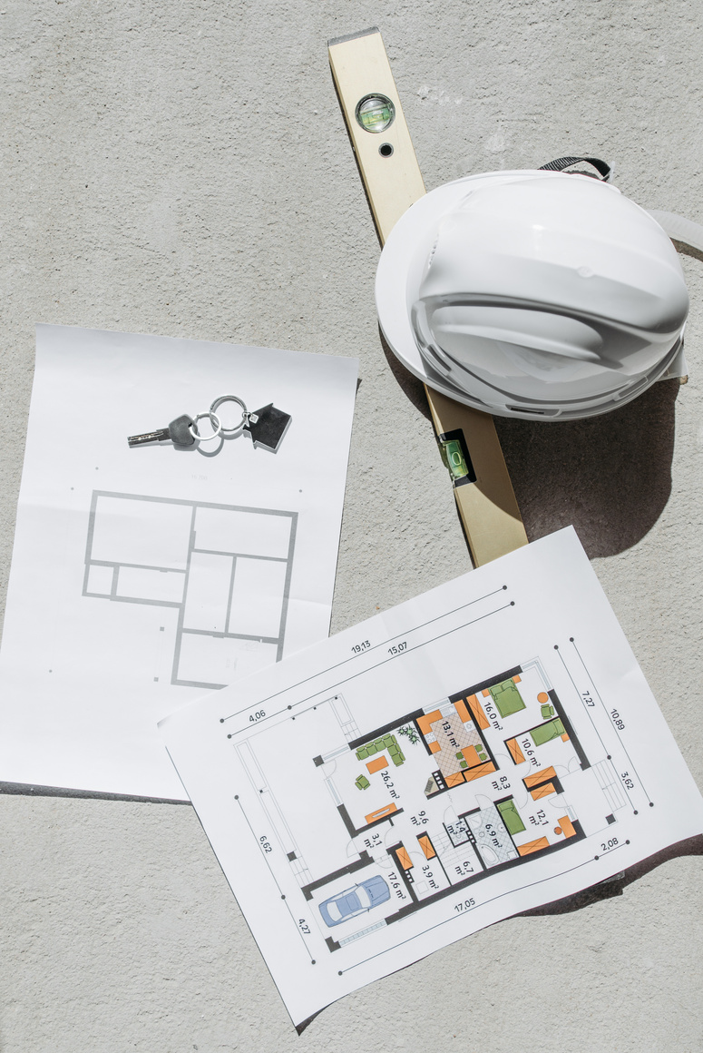 White Hard Hat Beside Floor Plans and House Key